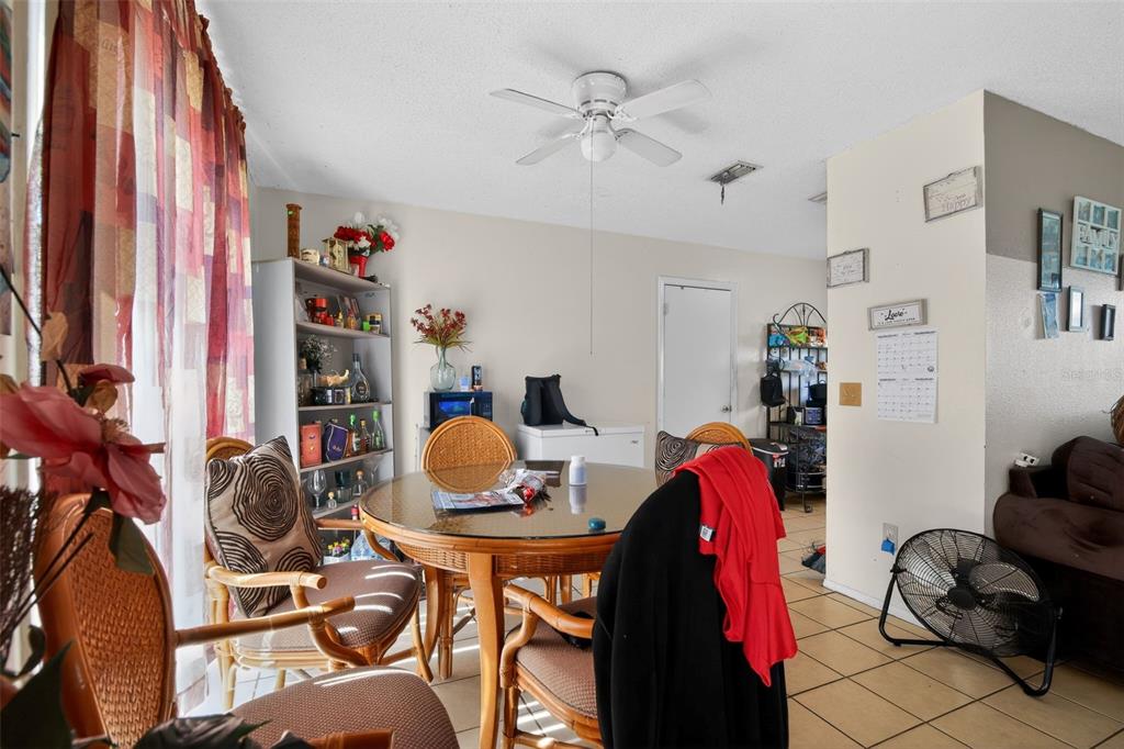 8821 Southeast 89th Place Ocala, FL 34472 - Photo 19 of 30 a living room with furniture and a chandelier