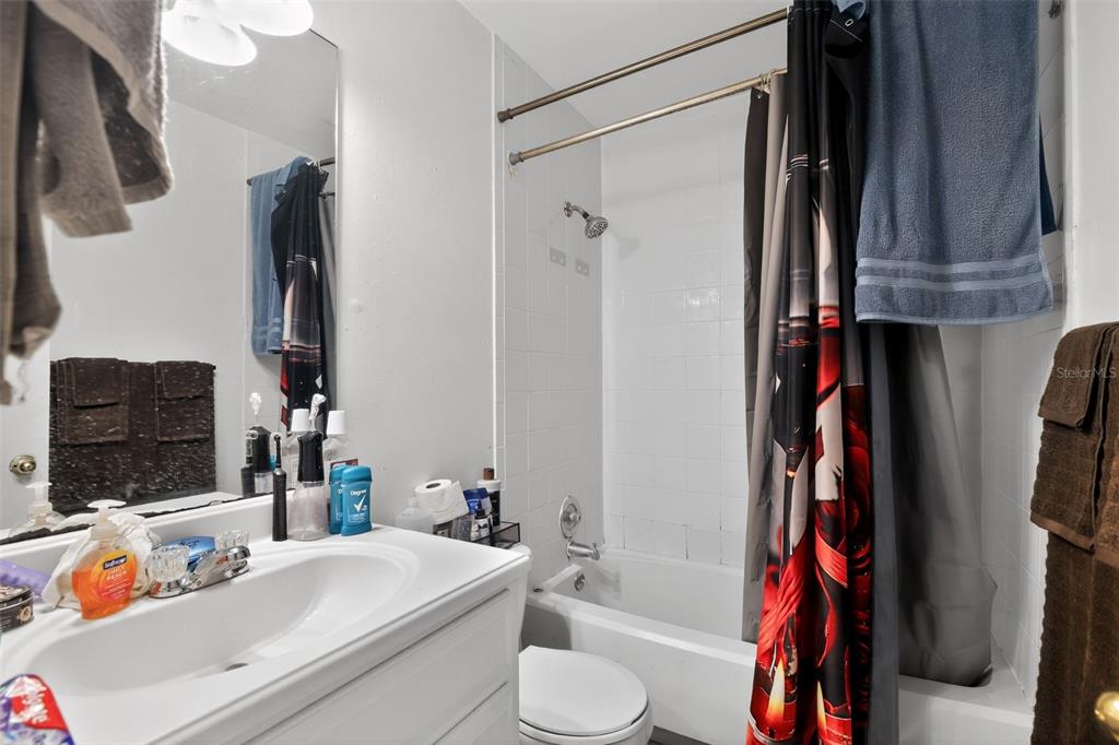 8821 Southeast 89th Place Ocala, FL 34472 - Photo 25 of 30 a bathroom with a sink toilet and shower