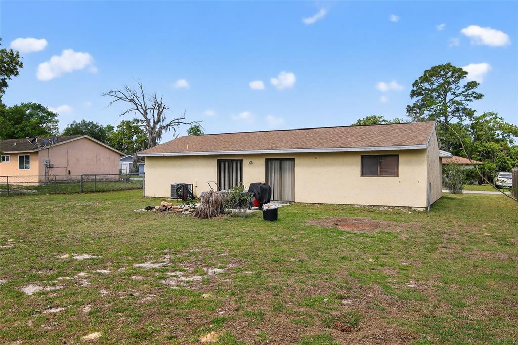 8821 Southeast 89th Place Ocala, FL 34472 - Photo 3 of 30 a view of a house with backyard
