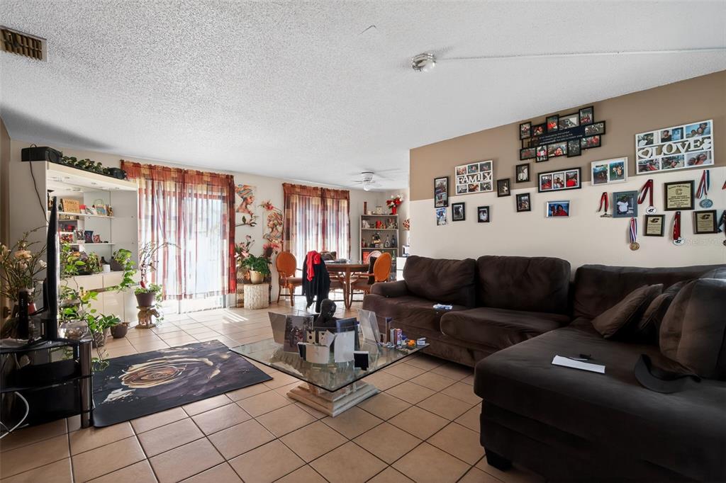 8821 Southeast 89th Place Ocala, FL 34472 - Photo 10 of 30 a living room with furniture and a flat screen tv