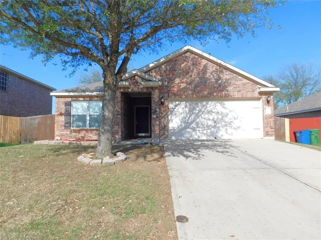 a view of a house with a yard and garage