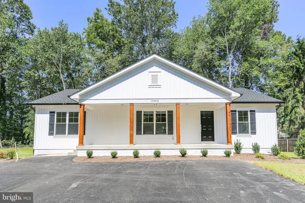 a front view of a house with a road
