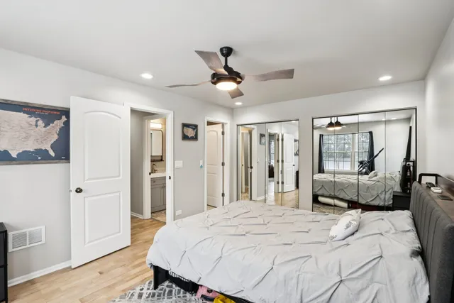 a bedroom with a large bed and a chandelier