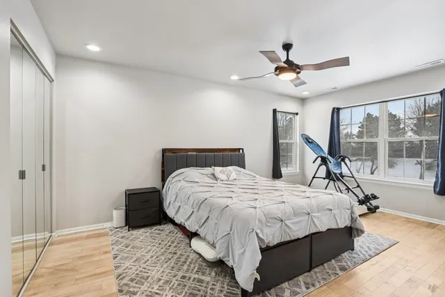 a bedroom with a bed and a large window