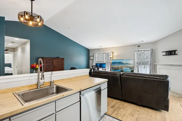 a kitchen with sink and refrigerator