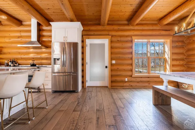 a living room with furniture a wooden floor and a chandelier