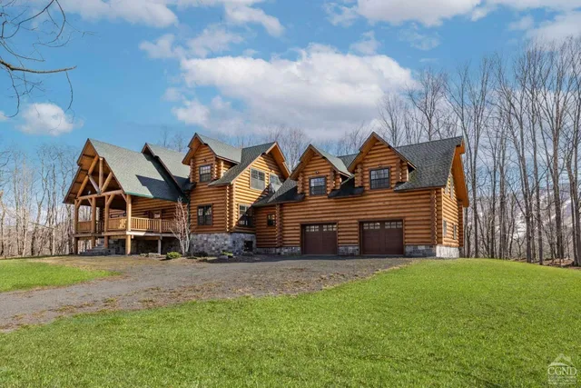 a front view of house with yard and green space