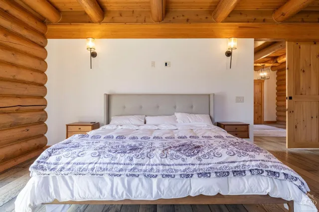 a bedroom with a bed and a large window