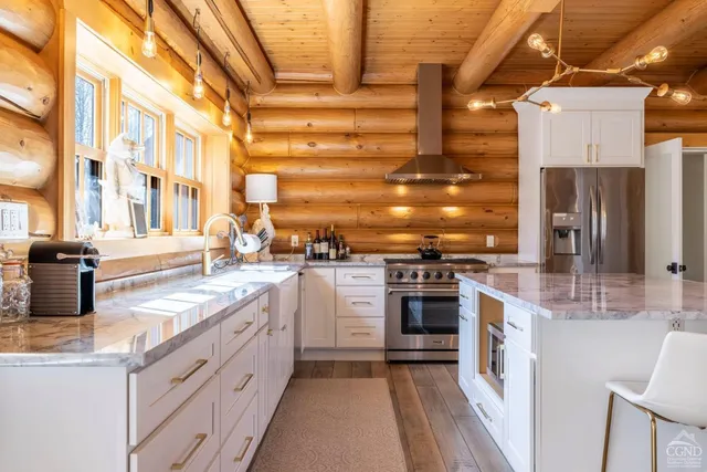 a kitchen with stainless steel appliances granite countertop a stove and cabinets
