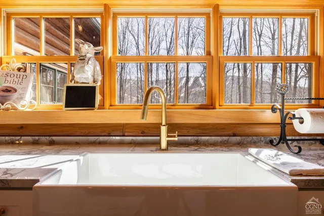 a kitchen with a stove a sink and cabinets