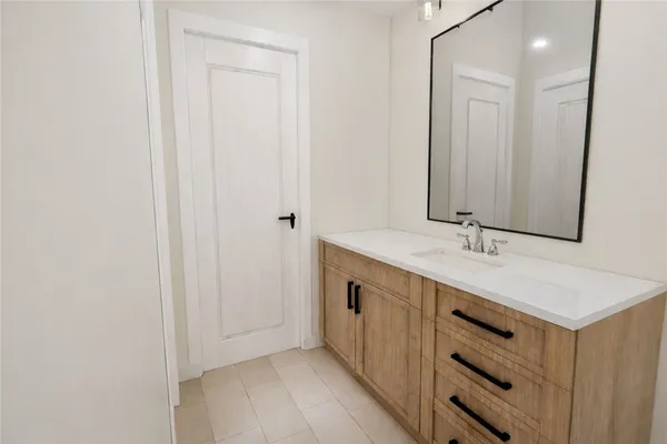 a bathroom with a sink a mirror and a vanity