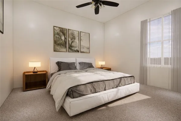 a bedroom with a bed and a painting on the wall