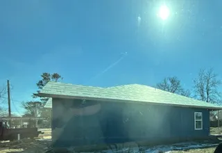 a view of a town with large trees and plants
