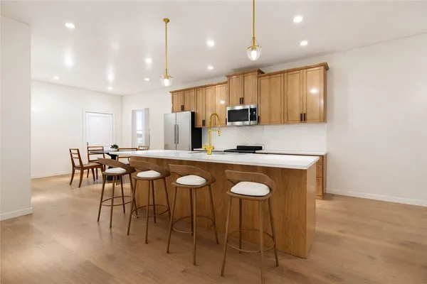 a large kitchen with a table and chairs