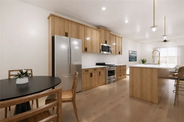 a kitchen with stainless steel appliances granite countertop a refrigerator a sink dishwasher a stove with wooden cabinets