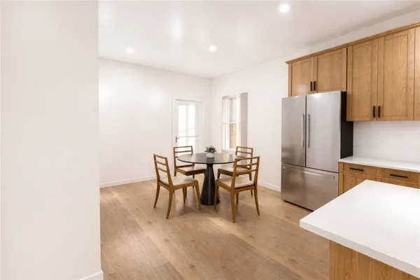 a dining room with furniture and a refrigerator