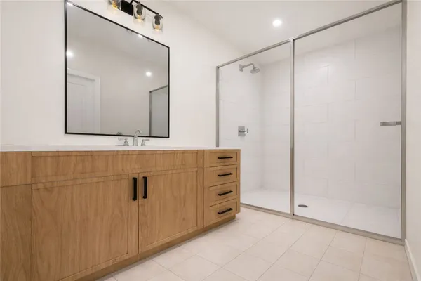 a bathroom with a shower and a mirror