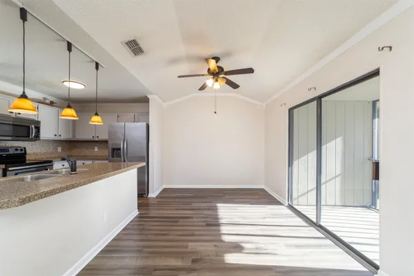 a kitchen with kitchen island white cabinets and stainless steel appliances