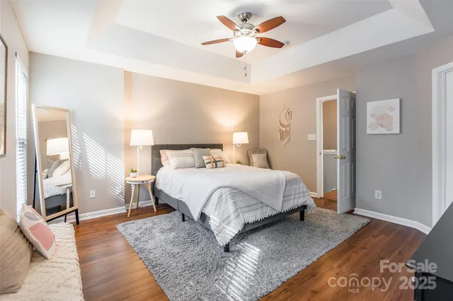a bedroom with a large bed and a chandelier