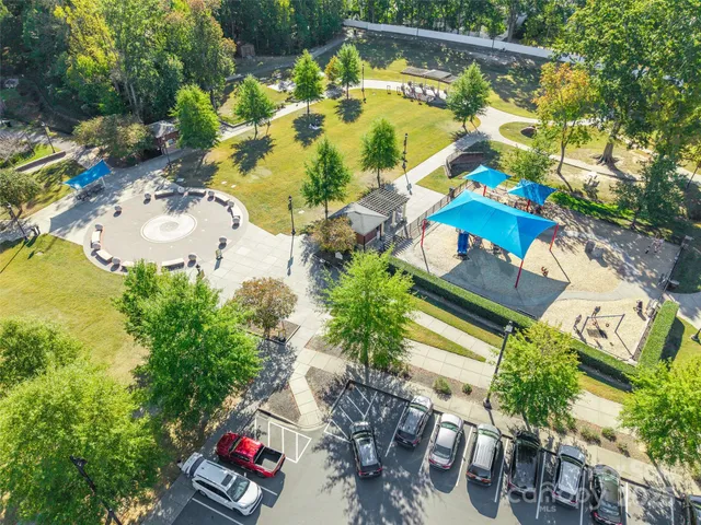 an aerial view of a house a yard swimming pool and outdoor seating
