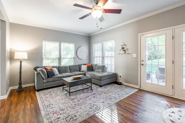 a living room with furniture and wooden floor