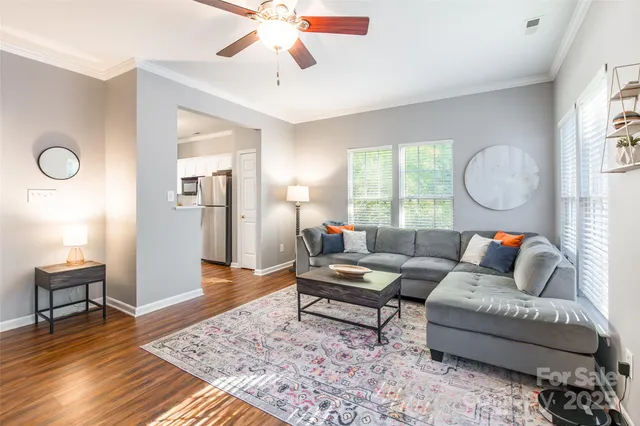 a living room with furniture and wooden floor