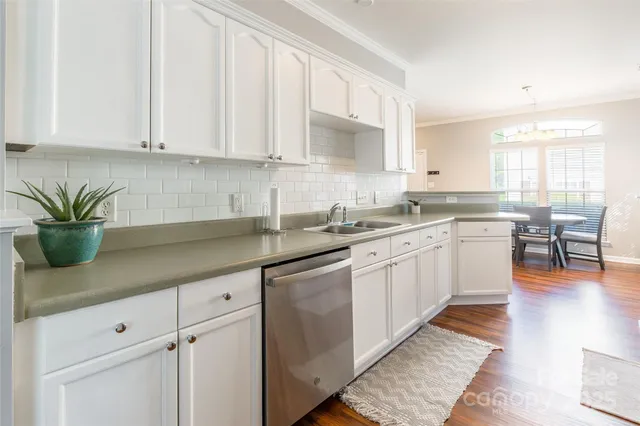 a kitchen with a white cabinets and sink