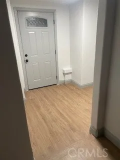 a view of a kitchen with a sink a microwave and cabinets