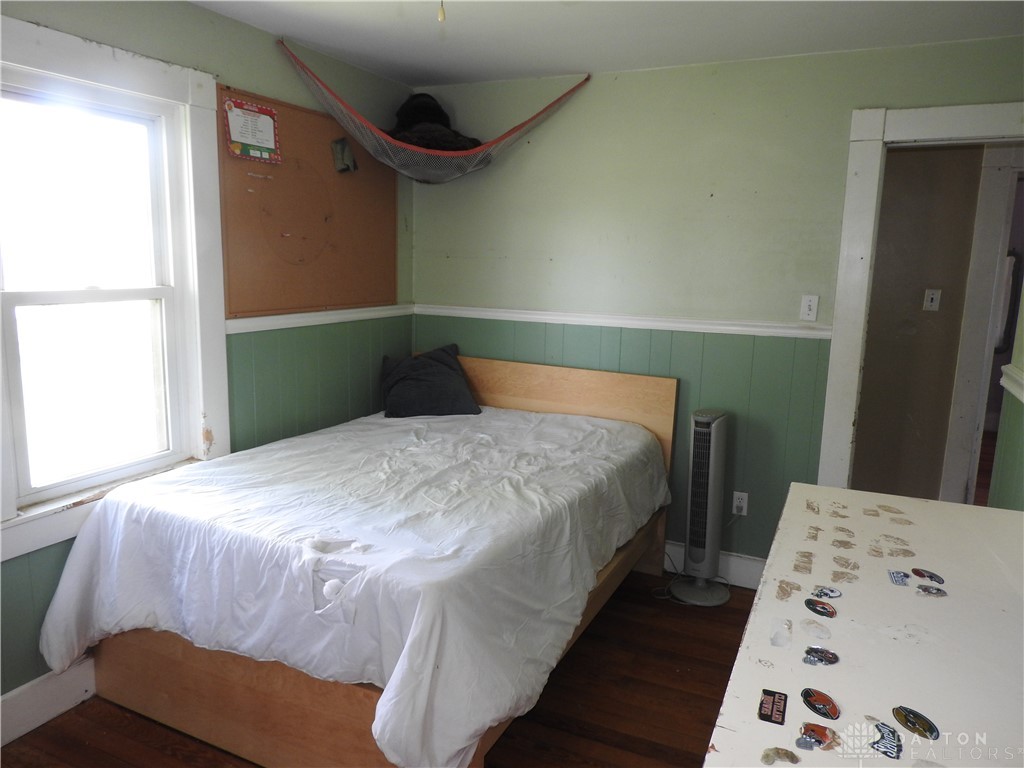 2105 East Loy Road Piqua, OH 45356 - Photo 26 of 26 Bright bedroom with natural light and classic hardwood floors.