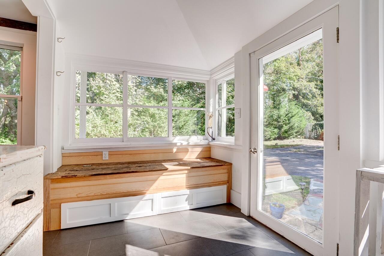 9 Locust Road Orleans, MA 02653 - Photo 12 of 41 a living room with a large window and a bed