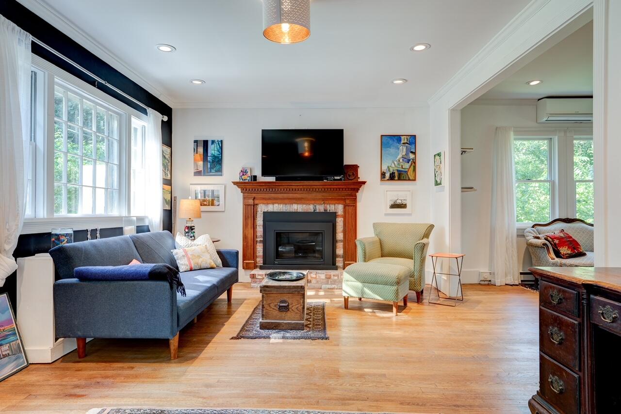 9 Locust Road Orleans, MA 02653 - Photo 13 of 41 a living room with furniture a flat screen tv and a fireplace