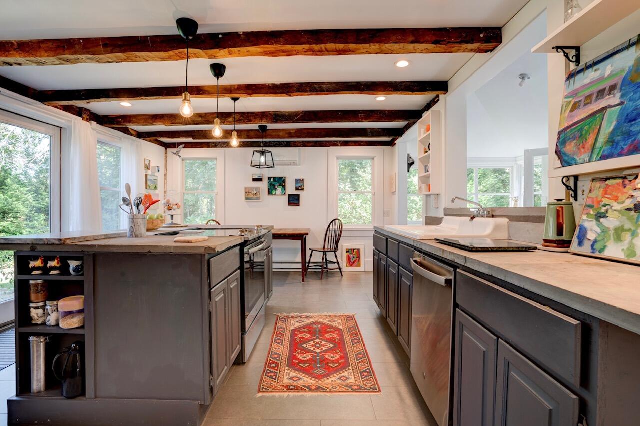9 Locust Road Orleans, MA 02653 - Photo 4 of 41 a open kitchen with stainless steel appliances granite countertop a stove a sink and a refrigerator
