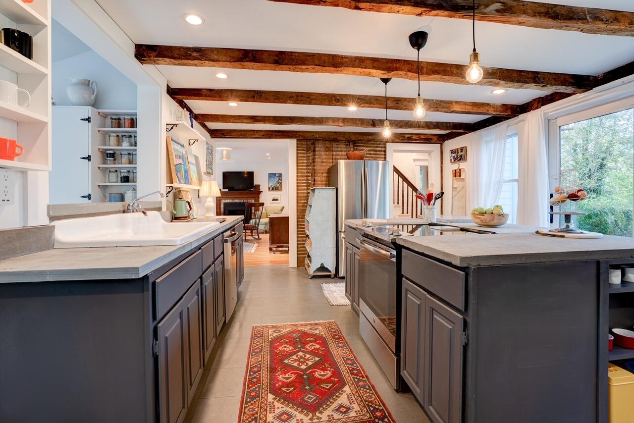 9 Locust Road Orleans, MA 02653 - Photo 9 of 41 a kitchen with a stove a sink and a refrigerator