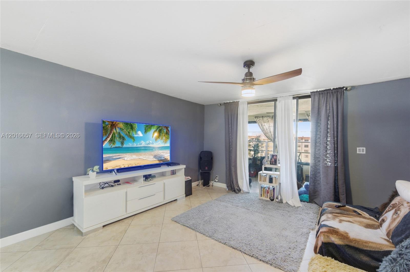 6195 Rock Island Road, Unit 511 Tamarac, FL 33319 - Photo 16 of 31 a living room with furniture and a flat screen tv