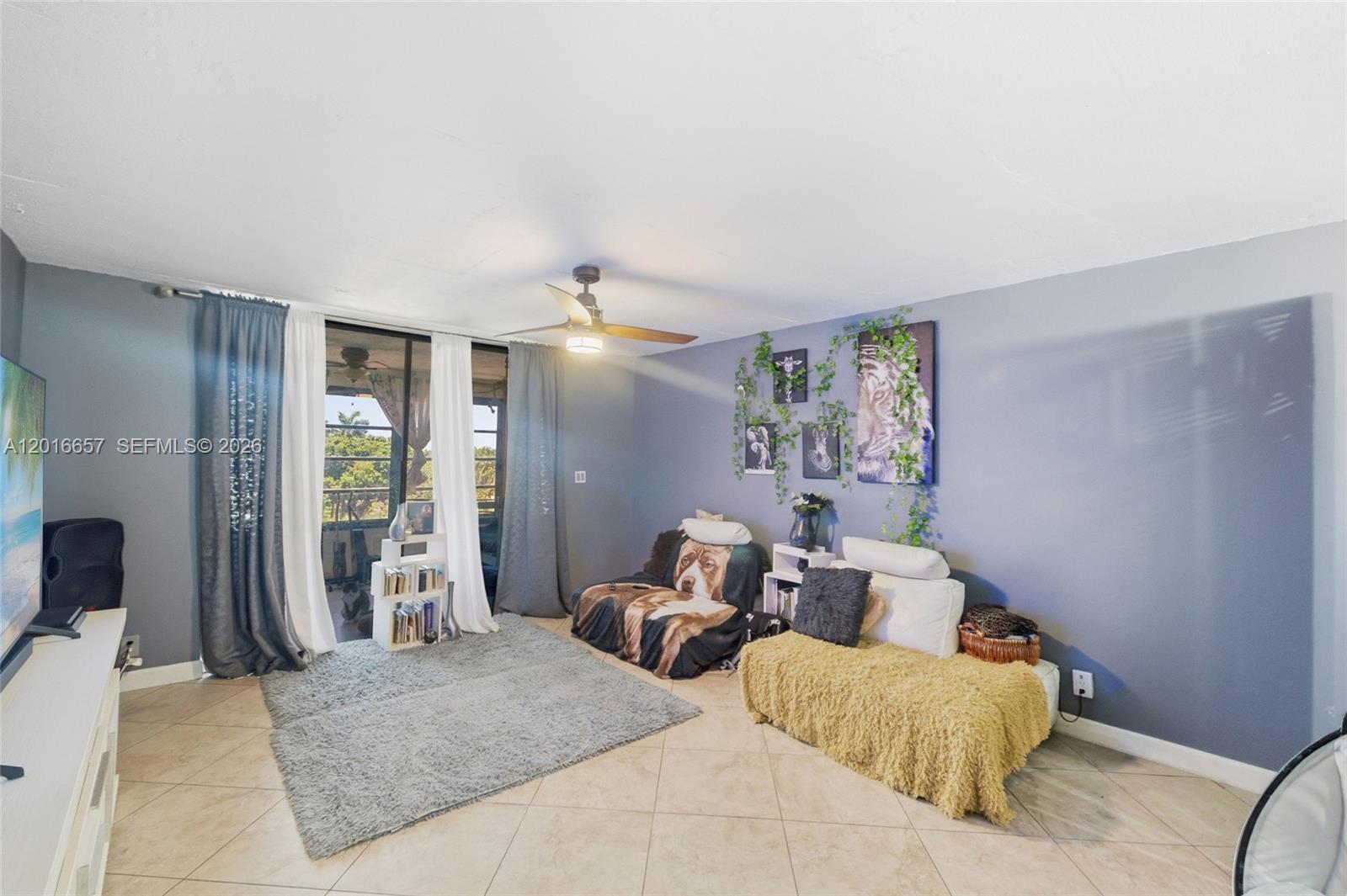 6195 Rock Island Road, Unit 511 Tamarac, FL 33319 - Photo 17 of 31 a bedroom with furniture and a large window