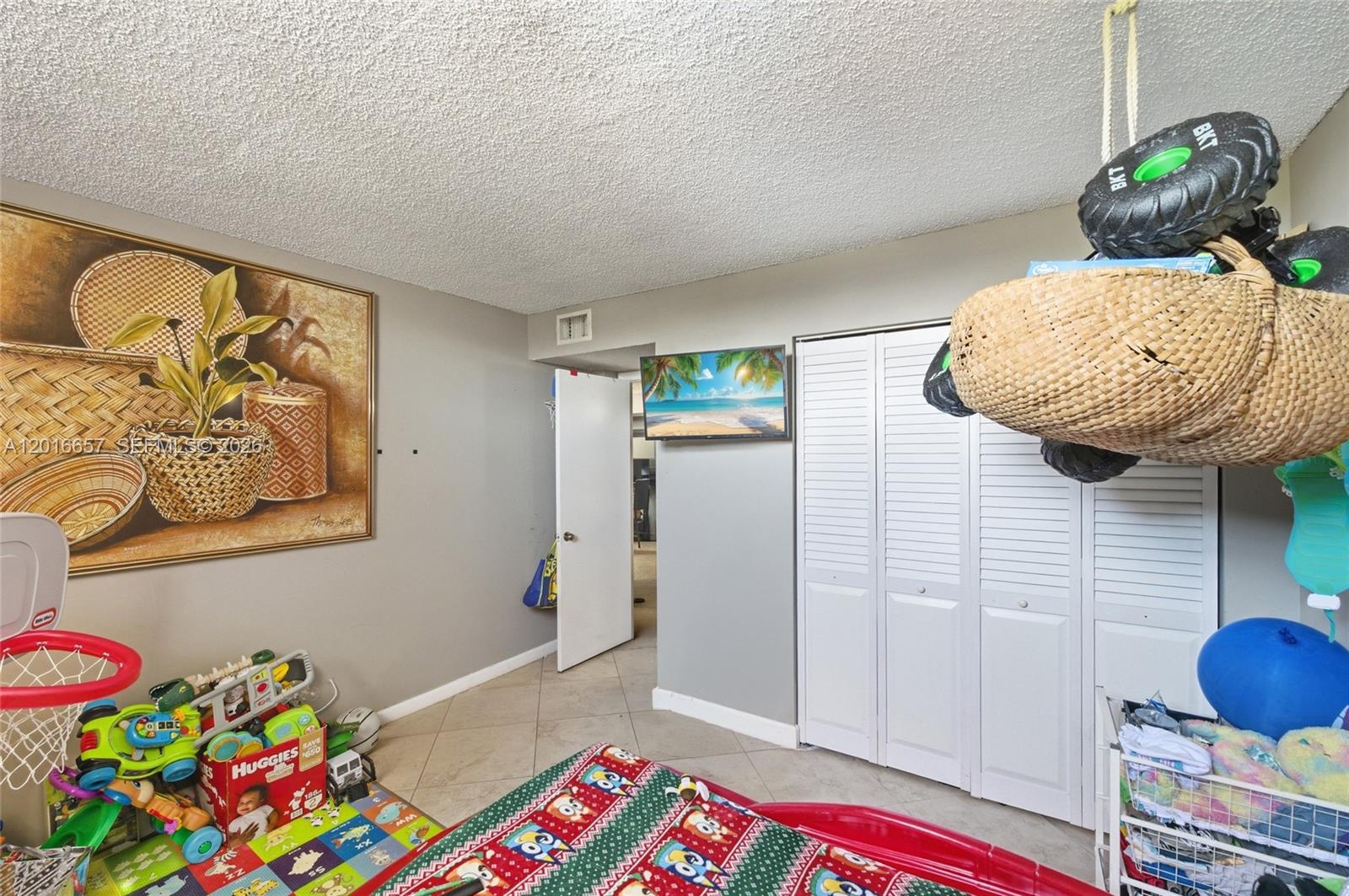 6195 Rock Island Road, Unit 511 Tamarac, FL 33319 - Photo 19 of 31 a bedroom with a bed and ceiling fan