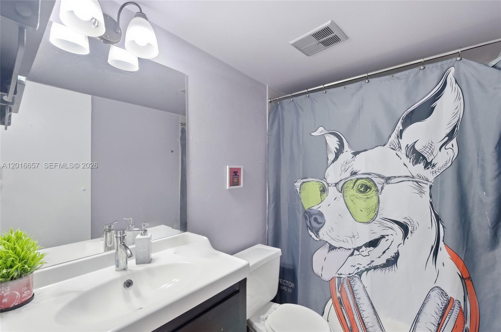 6195 Rock Island Road, Unit 511 Tamarac, FL 33319 - Photo 22 of 31 a bathroom with a granite countertop bathtub a sink and a mirror