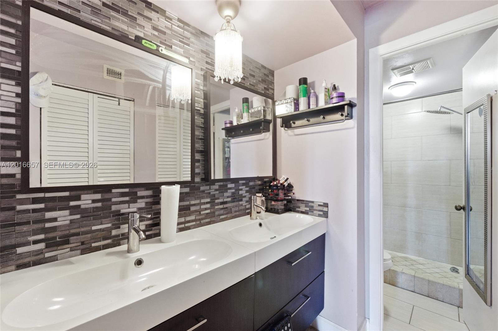 6195 Rock Island Road, Unit 511 Tamarac, FL 33319 - Photo 4 of 31 a bathroom with a sink and a mirror