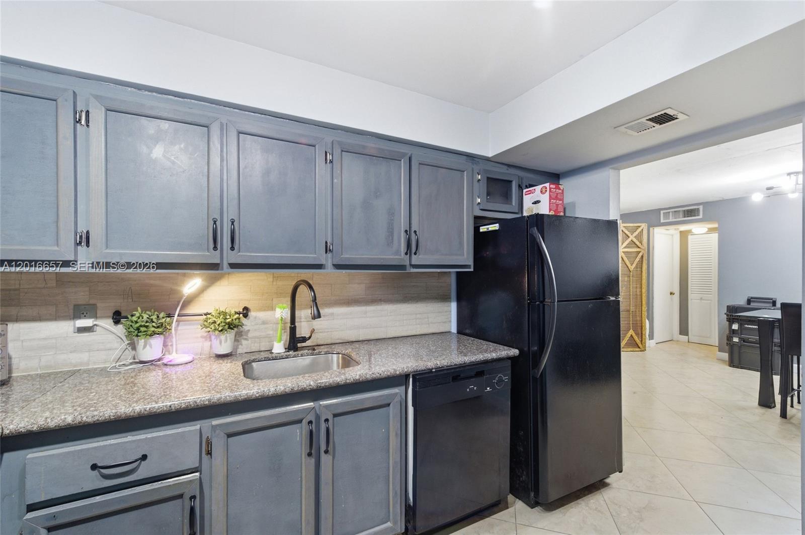 6195 Rock Island Road, Unit 511 Tamarac, FL 33319 - Photo 6 of 31 a kitchen with stainless steel appliances granite countertop a refrigerator and a sink