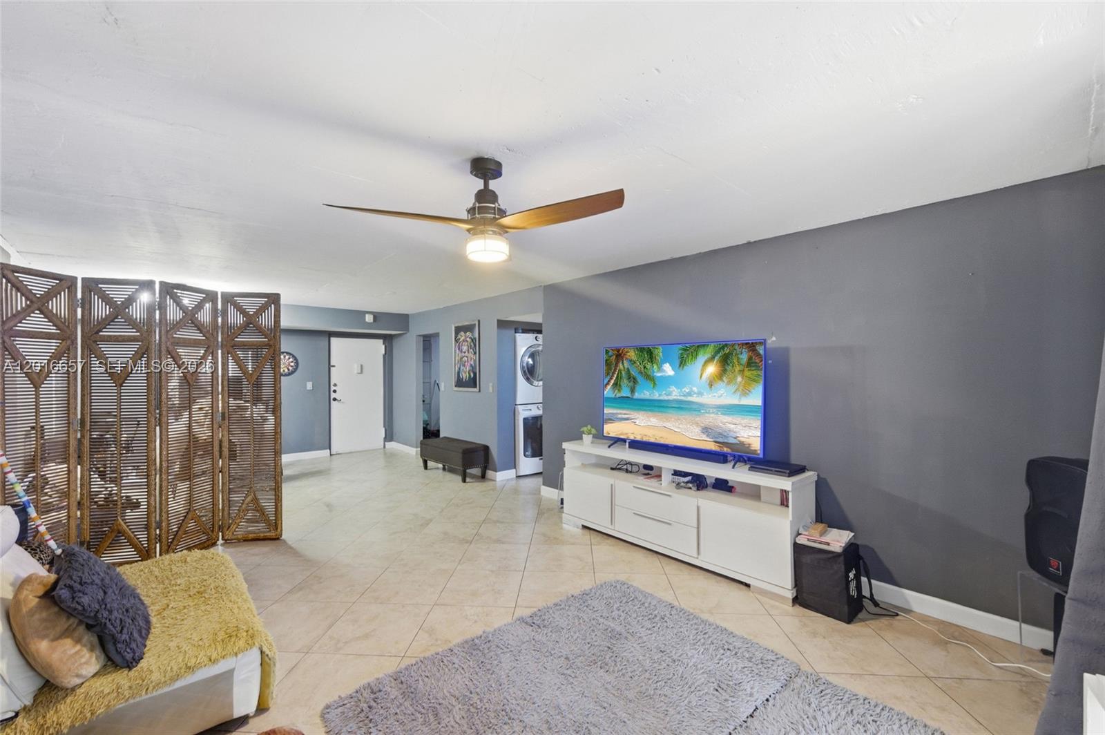 6195 Rock Island Road, Unit 511 Tamarac, FL 33319 - Photo 8 of 31 a living room with furniture and a flat screen tv