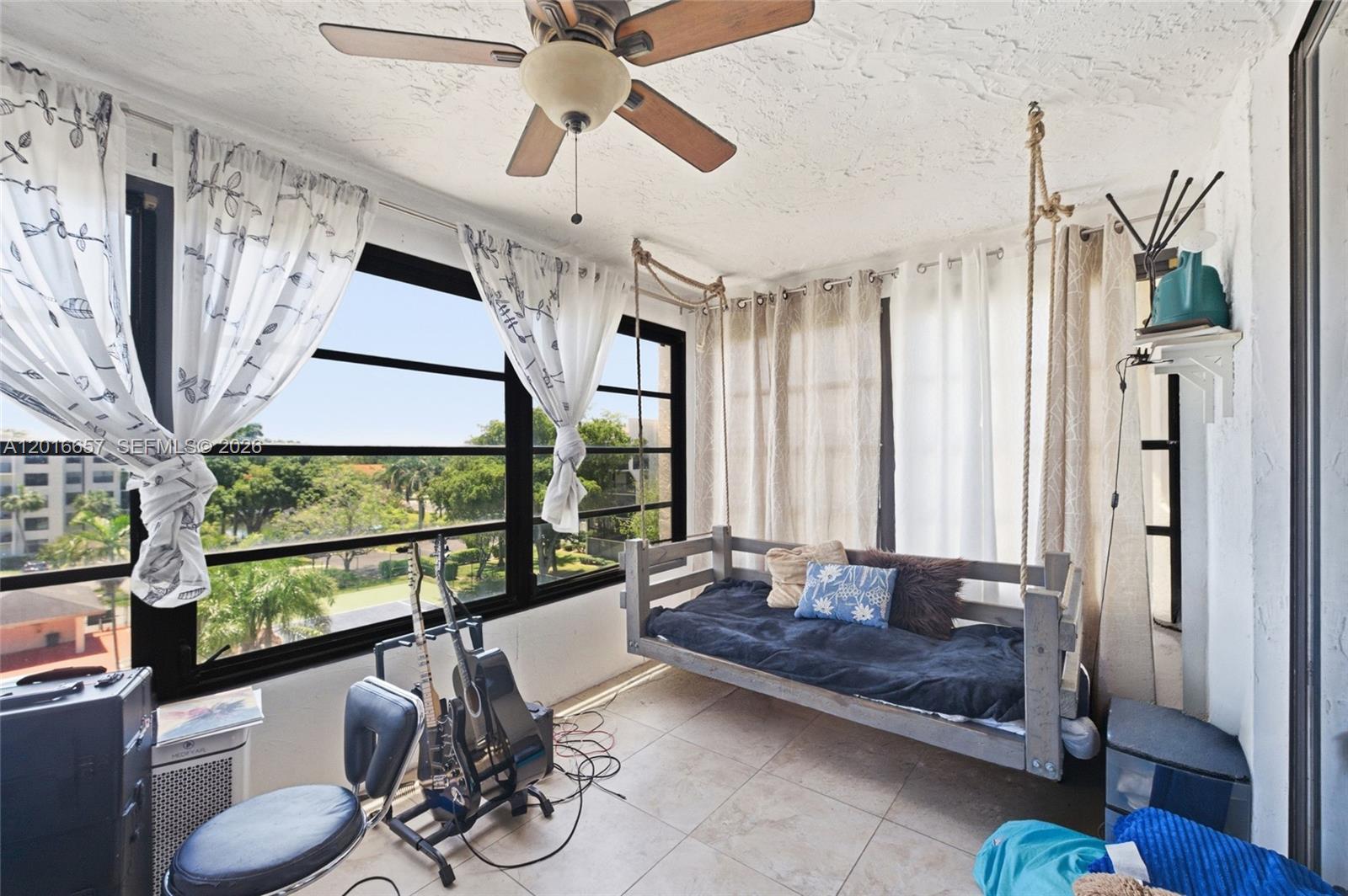6195 Rock Island Road, Unit 511 Tamarac, FL 33319 - Photo 10 of 31 a living room with furniture and a large window
