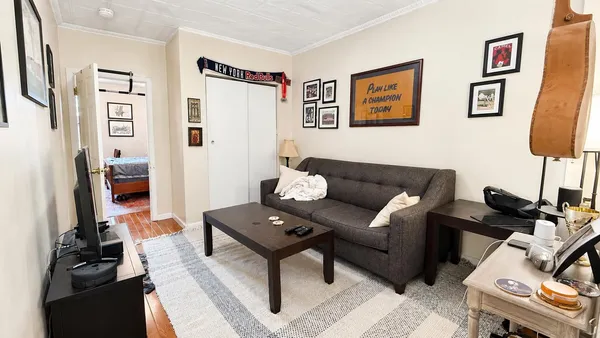 a living room with furniture a rug and a flat screen tv