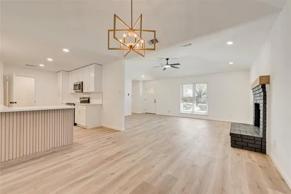 a view of a kitchen with a sink and wooden floor