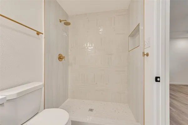 a bathroom with a shower and a toilet