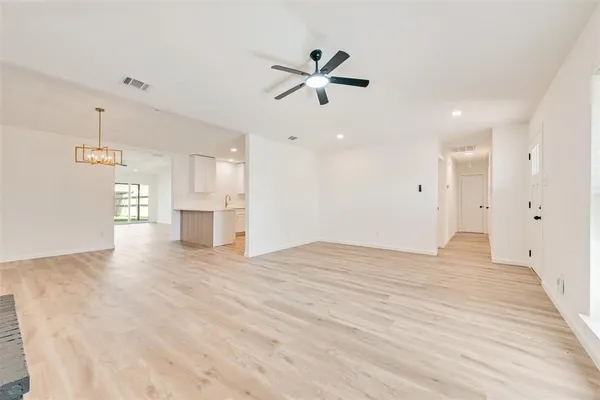 a view of an empty room with a ceiling fan