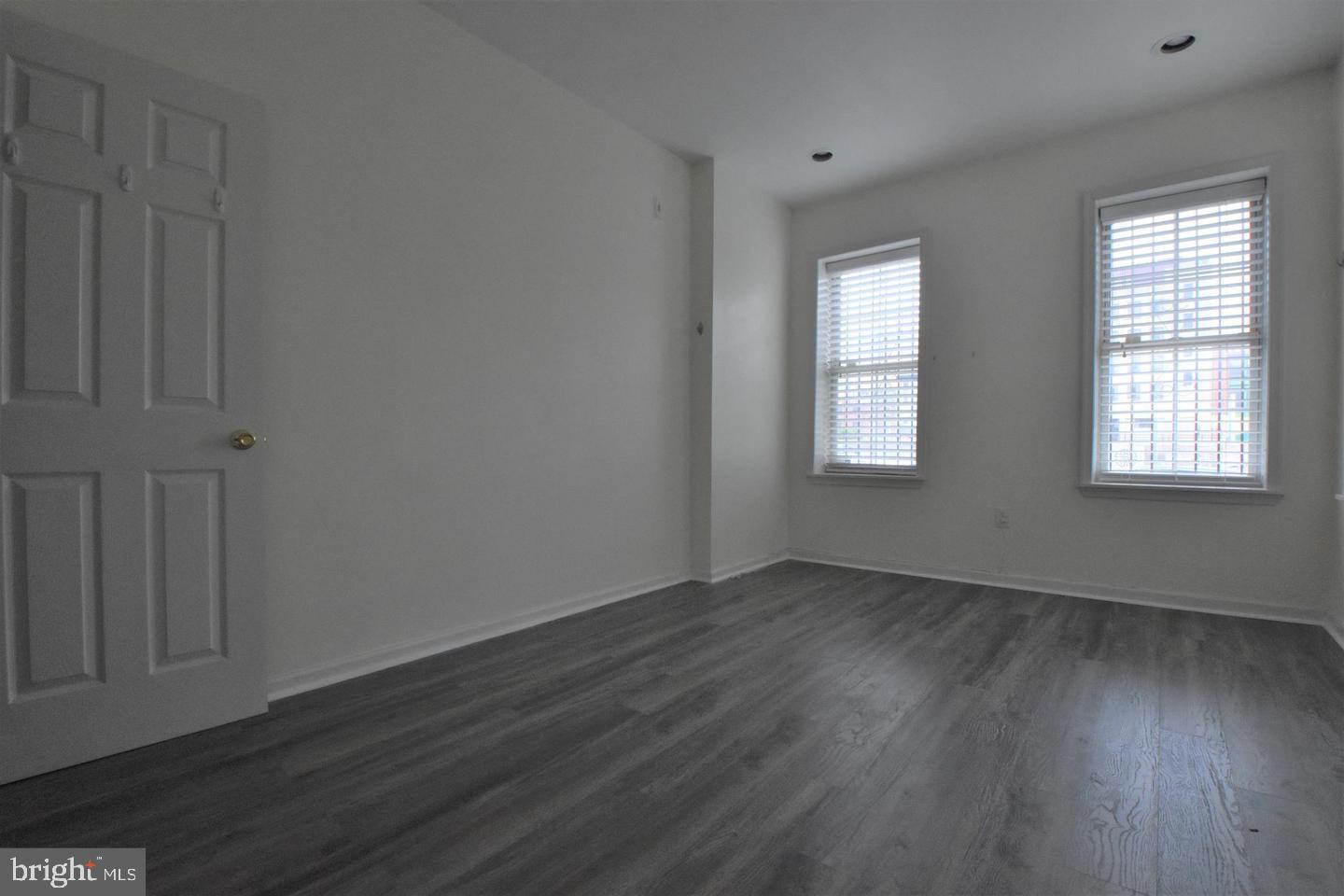 1224 Summer Street, Unit 1 Philadelphia, PA 19107 - Photo 5 of 6 an empty room with wooden floor and windows