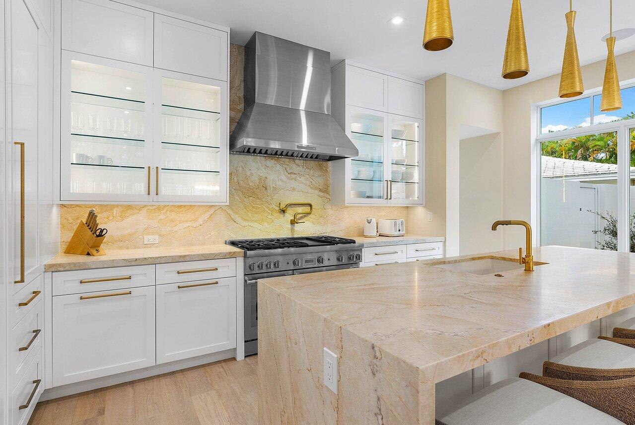 909 Bond Way Delray Beach, FL 33483 - Photo 17 of 43 a kitchen with stainless steel appliances granite countertop a sink and cabinets
