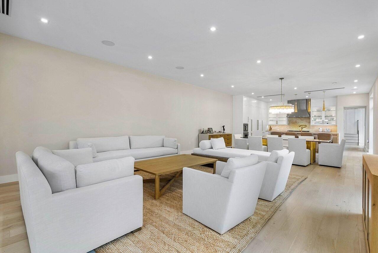 909 Bond Way Delray Beach, FL 33483 - Photo 21 of 43 a living room with fireplace furniture and a view of kitchen