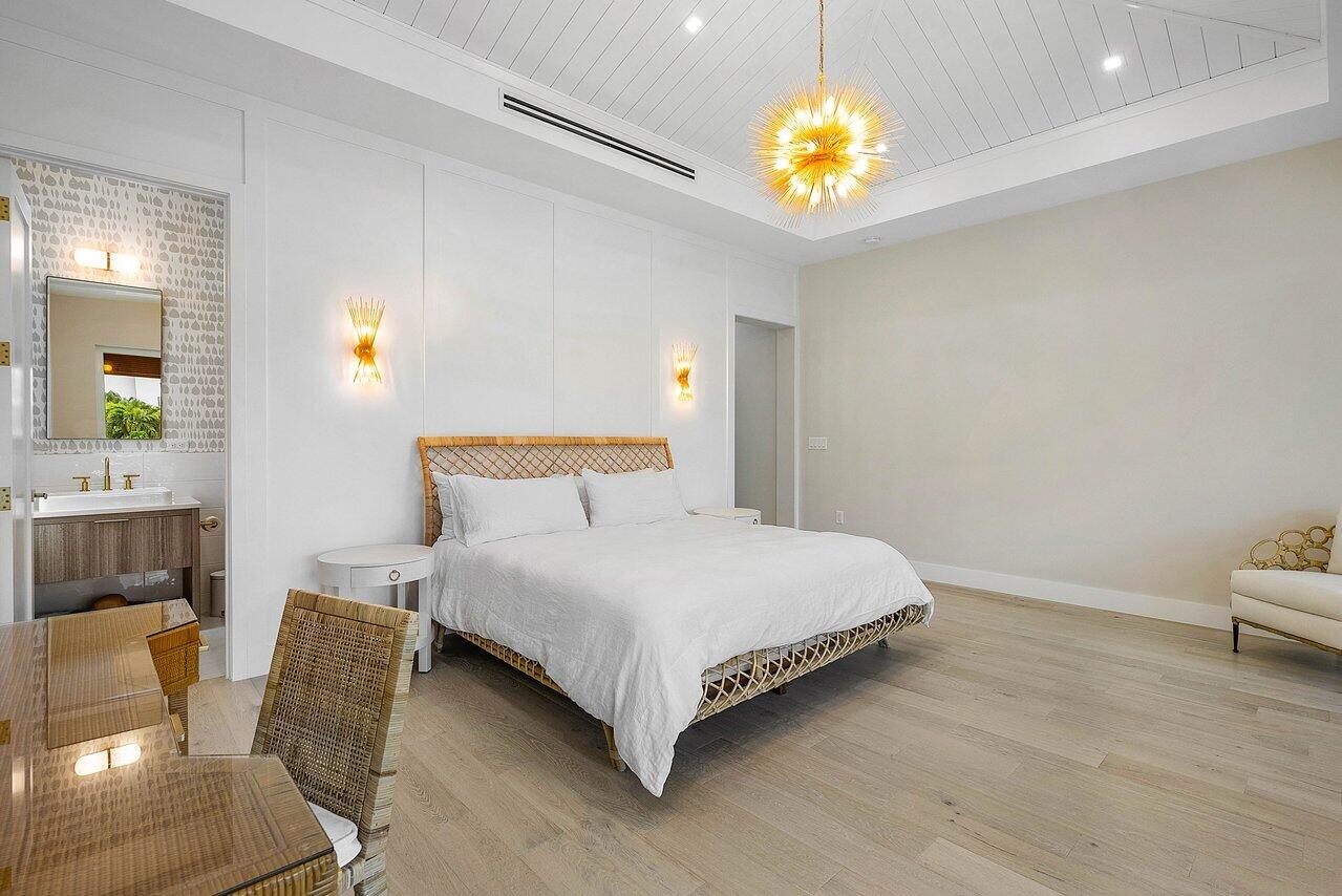 909 Bond Way Delray Beach, FL 33483 - Photo 27 of 43 a bedroom with a bed and a chandelier