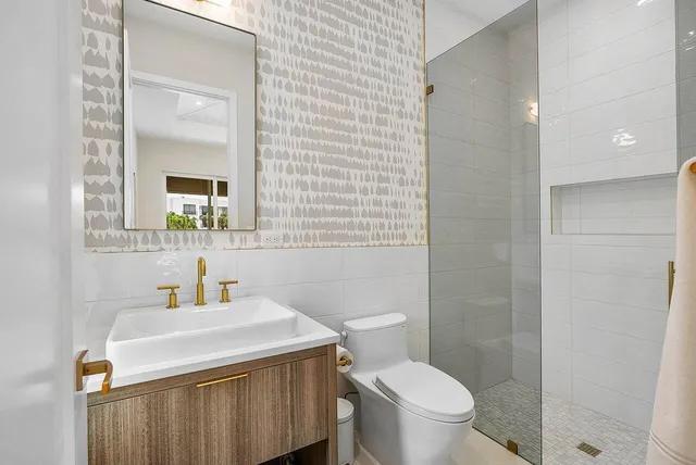 a bathroom with a sink toilet and mirror